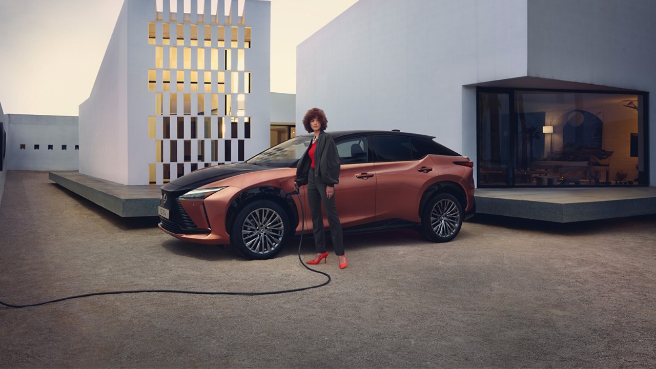 A person charging a Lexus RZ